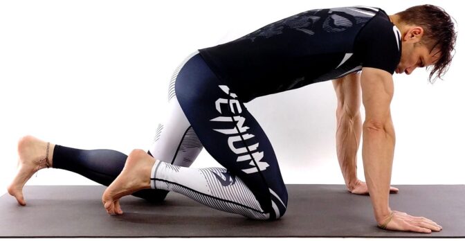 Person doing yoga pose on a mat.